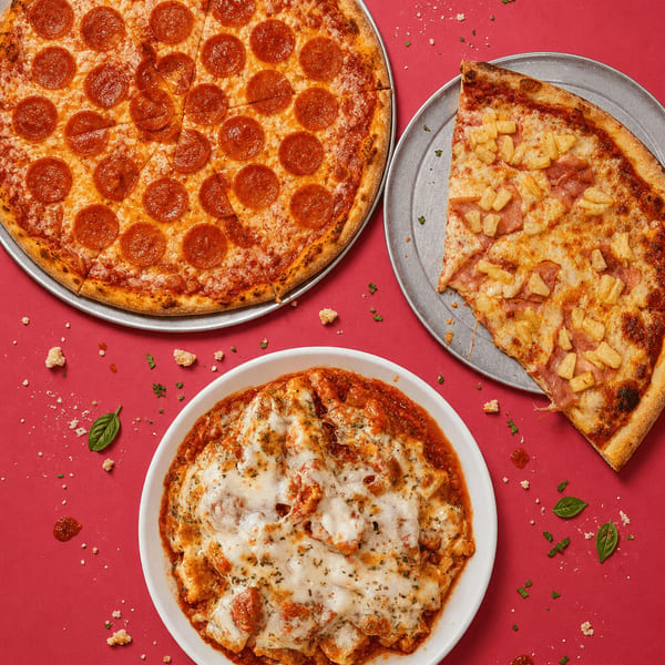 Fully loaded custom pizza with bubbling cheese fresh from the stone oven